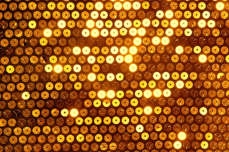 Sparkling, metallic, golden, sequined textile for disco, party or fashion designsの写真素材
