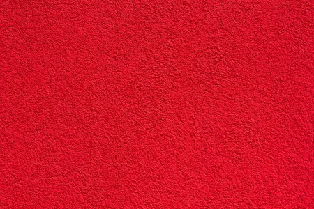 red horizontal wall covered with plaster textureの写真素材