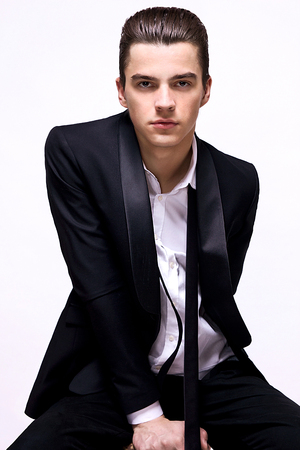 young male model looking into the camera, white background, isolatedの写真素材