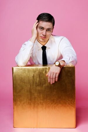 young man holding a large gift boxの写真素材