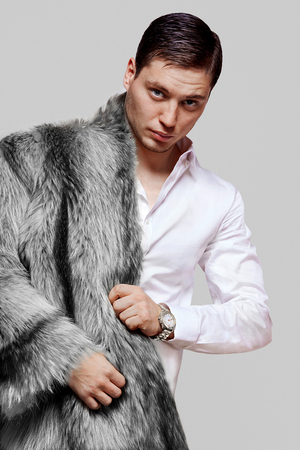 Nice man in a fur coat from a black foxの写真素材