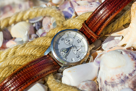 Mens watches lie on the beachの写真素材