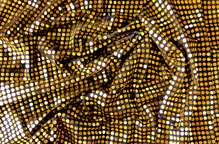 Golden sequins on a black background, fabric, background, textileの写真素材