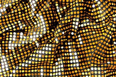 Golden sequins on a black background, fabric, background, textileの写真素材