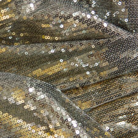 Silver fabric with paillettes, cast in goldの写真素材