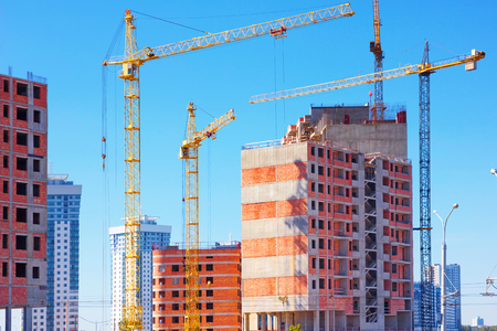 Lots of tower cranes build large residential buildingsの写真素材