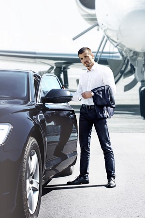 Businessman opens the car doorの写真素材