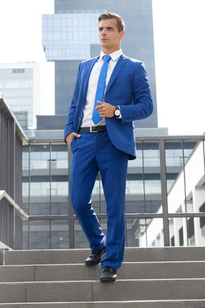Stylish man posing against the background of a modern buildingの写真素材