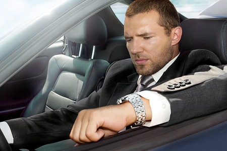 portrait of a man sitting in a gray blue carの写真素材