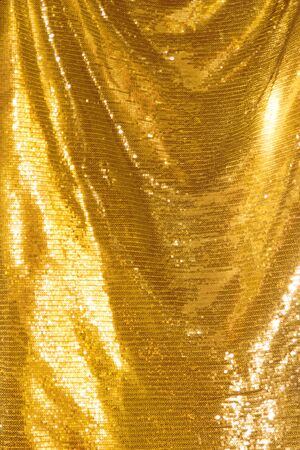 Golden sequins - sparkling sequined textileの写真素材