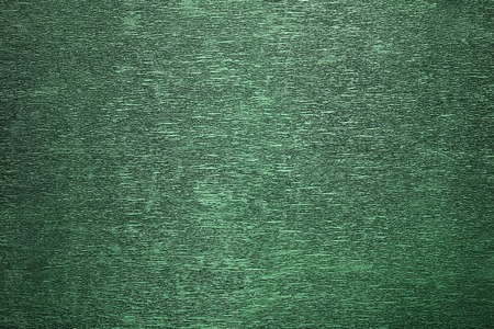 texture of green glitter paper background for design Christmas or New Year's cardsの写真素材