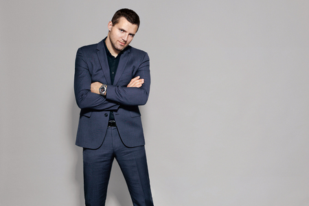 man in blue suit on gray background studioの写真素材