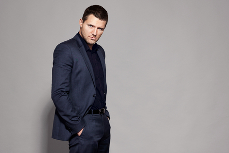 man in blue suit on gray background studioの写真素材