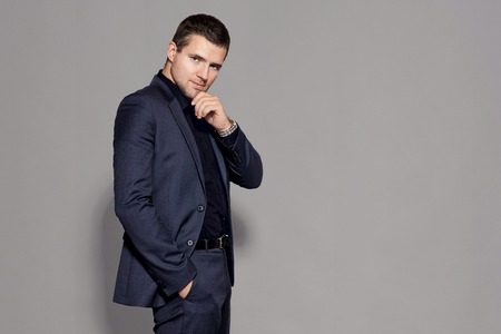 man in blue suit on gray background studioの写真素材
