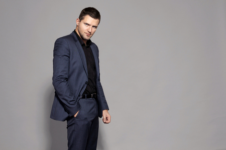 man in blue suit on gray background studioの写真素材