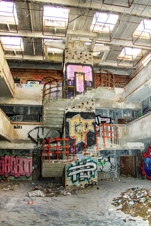 The old abandoned building with garbage and painted graffiti insideの写真素材