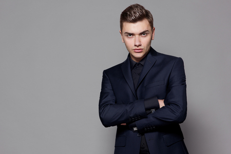 man in suit against gray background, studioの写真素材