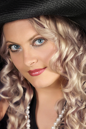 portrait of a blonde girl close-up with curled hairの写真素材