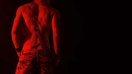 man on a black background over jeans and suspenderの写真素材