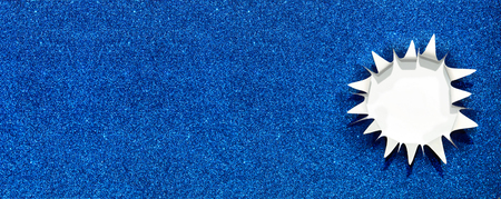 shiny blue paper with a ragged hole that looks like a starの写真素材