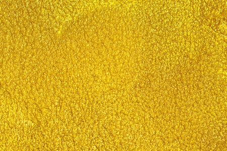 Golden yellow seamless plaster background grunge stone texture, gold or foil color on stone surface texture backgroundの写真素材