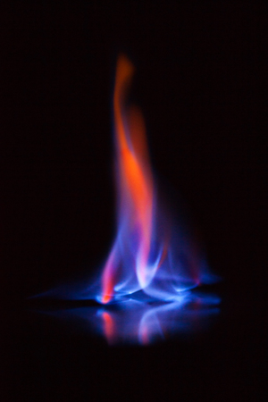Flame of burning alcohol on black background. Gas flame. Black background. Abstract blaze fire flame texture background.の写真素材