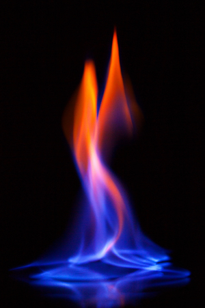 Flame of burning alcohol on black background. Gas flame. Black background. Abstract blaze fire flame texture background.の写真素材