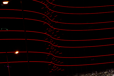 red neon lights of the building. Neon lights building. Night city, dark street. Colorful neon light.の写真素材