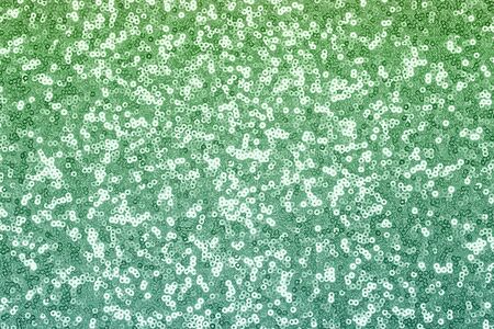 Sparkling pink, menthol, emerald sequin textile background. Fashion fabric glitter, sequinsの写真素材
