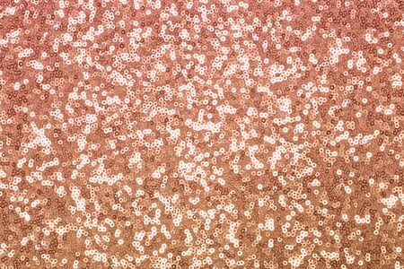 Sparkling pink, caramel, caramel sequin textile background. Fashion fabric glitter, sequinsの写真素材