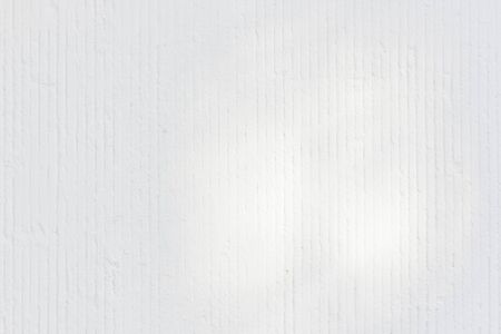 Solar glare and shadows on the wall from the leavesの写真素材