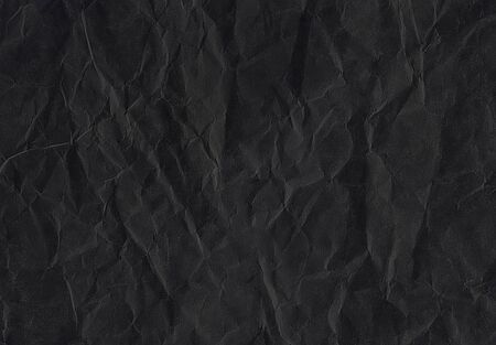  rumpled dark black matte paper. Texture of old dark black paper closeup.の写真素材