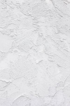 white old wall, cracked concrete background, white decorative plasterの写真素材