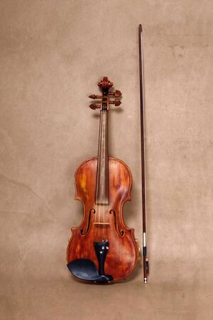 Violin musical instrument orchestra close up isolated on old brown backgroundの写真素材