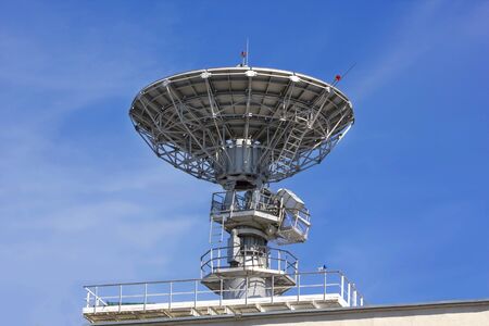 Metal reflector dish in action on the roof of an office buildingの写真素材