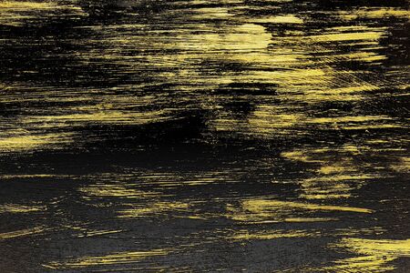 black textured wall with golden strokesの写真素材