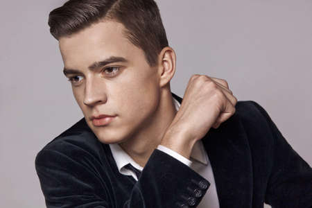 Young brunette man in blue velvet jacket, fashion.の写真素材