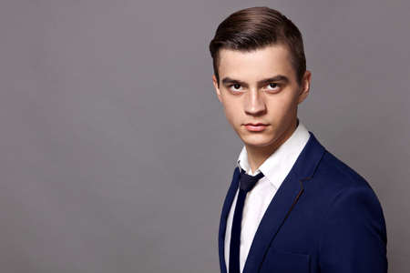 portrait of a young guy in a white shirt with hands closeの写真素材