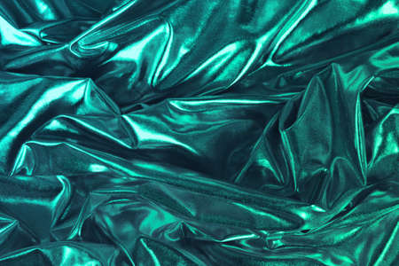 Soft silk cloth or satin fabric texture. Tidewater Green is a 2021 Color Trend.の写真素材