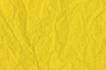 Crumpled yellow paper. Your background for a festive banner.の写真素材