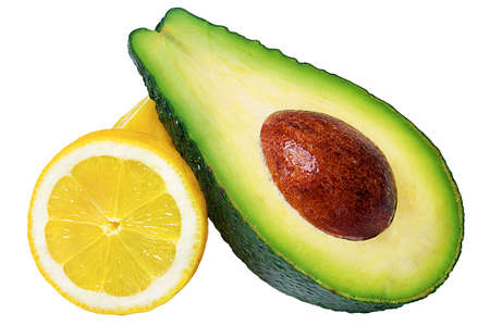 Cut avocado with seed and lemon cut isolated on white background and lemon isolatedの写真素材