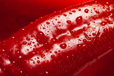 Macro of a grilled red pepper. Food texture. Red pepper, leather texture with water drops backgroundの写真素材