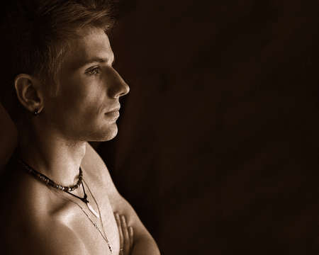 Sepia portrait, profile of young interesting man.の写真素材