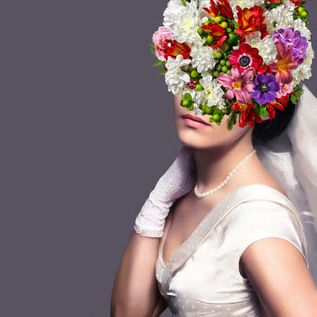 Bride with floral hairstyle. Woman with a bouquet on her head. Vogue style portrait.の写真素材