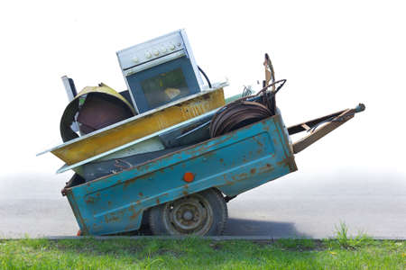 old gas oven is taken to a landfill in a car trailerの写真素材