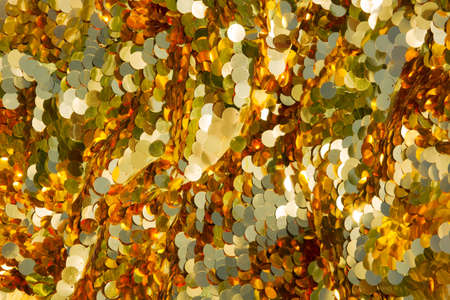 Bright golden round sequins background, backdrop for your advertisingの写真素材