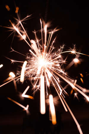 Burning sparkler on a dark background. Celebration concept, party.の写真素材