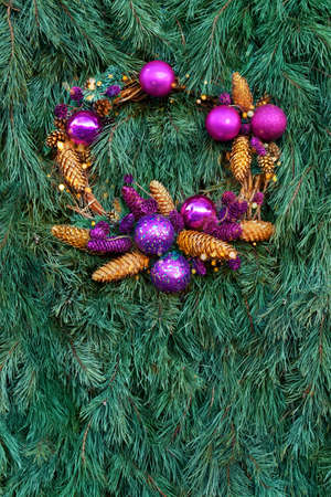 A wreath of New Year's branches of spruce, pine, fir, purple, lilac, balls of conesの写真素材