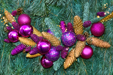 Lilac balls and cones on a spruce branch, christmas compositionの写真素材