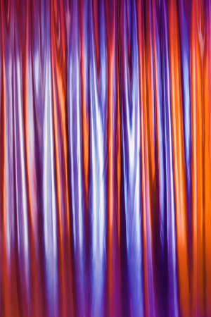 Smooth glossy abstract draped background in neon light. Neon red-blue wave.の写真素材